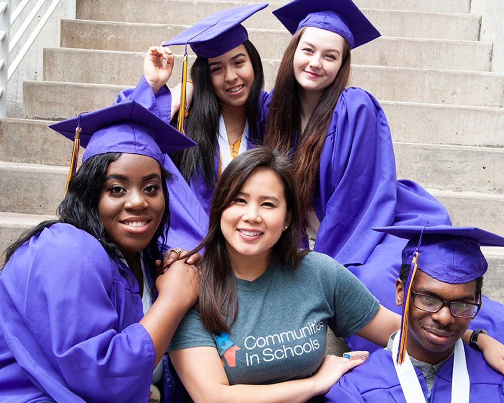 graduates together on steps