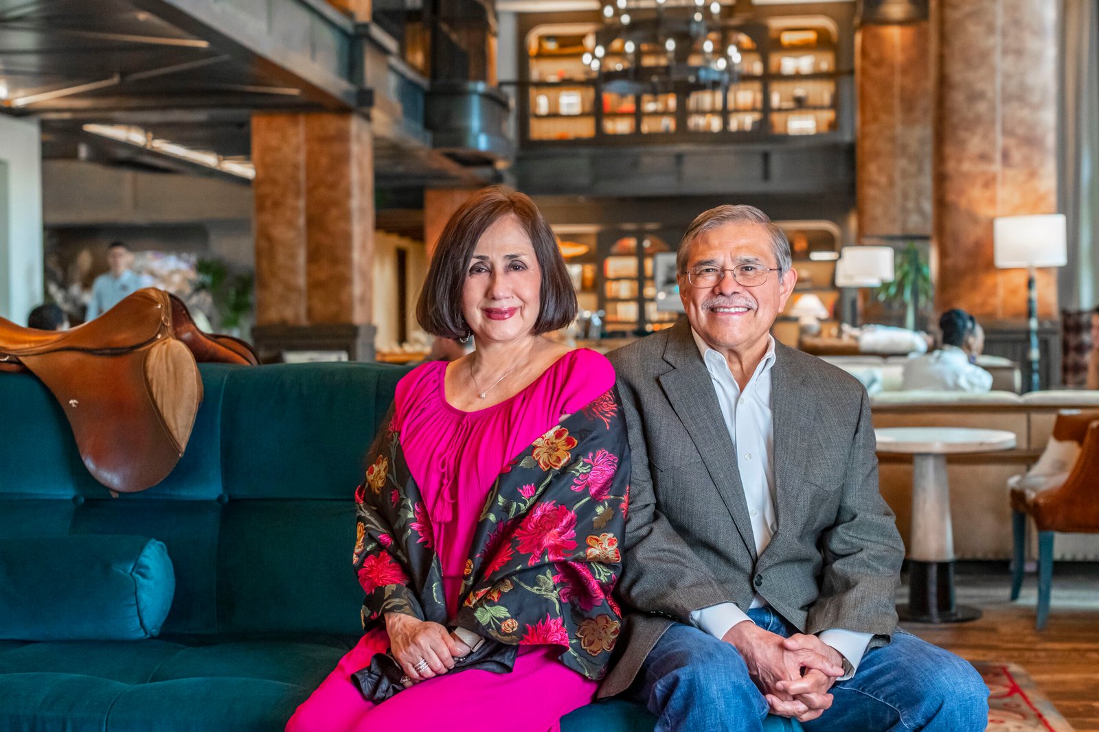Photo of a woman and a man sitting on a blue couch.