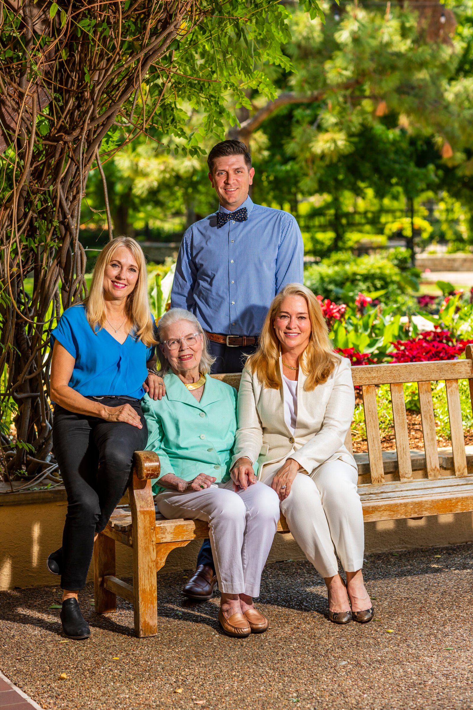 Photo of a family sitting outside on a park bench.