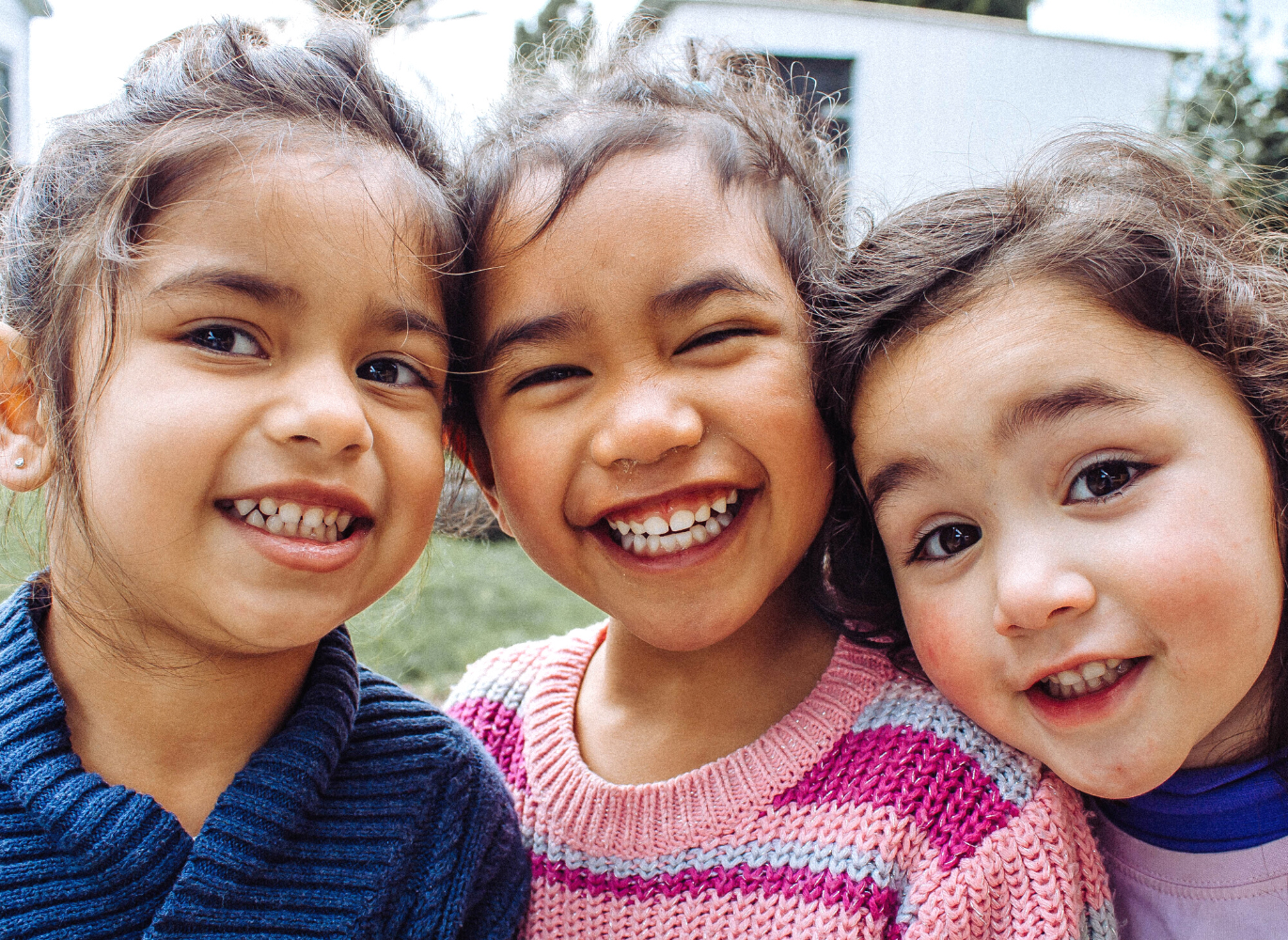 Photo of three children posing for a photo