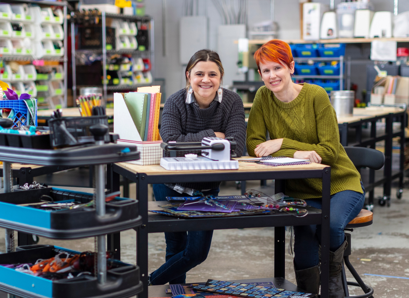 Photo of two females working at a desk.